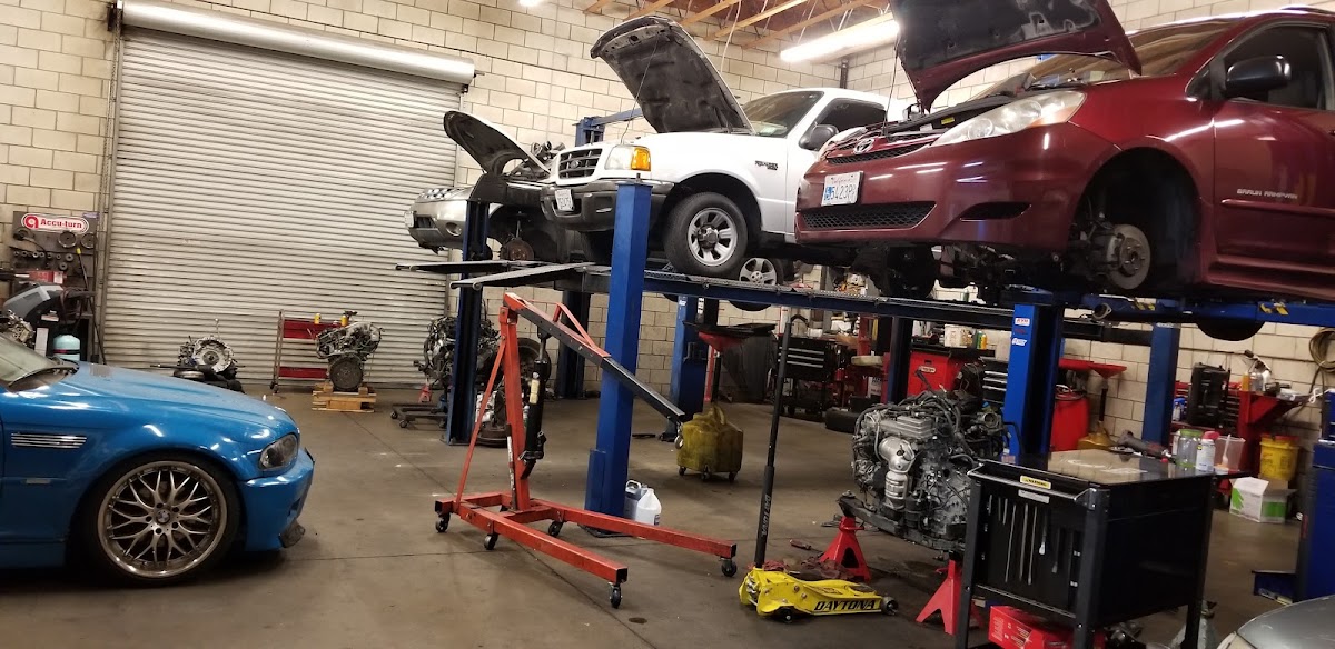 The full workshop with several cars up on lifts